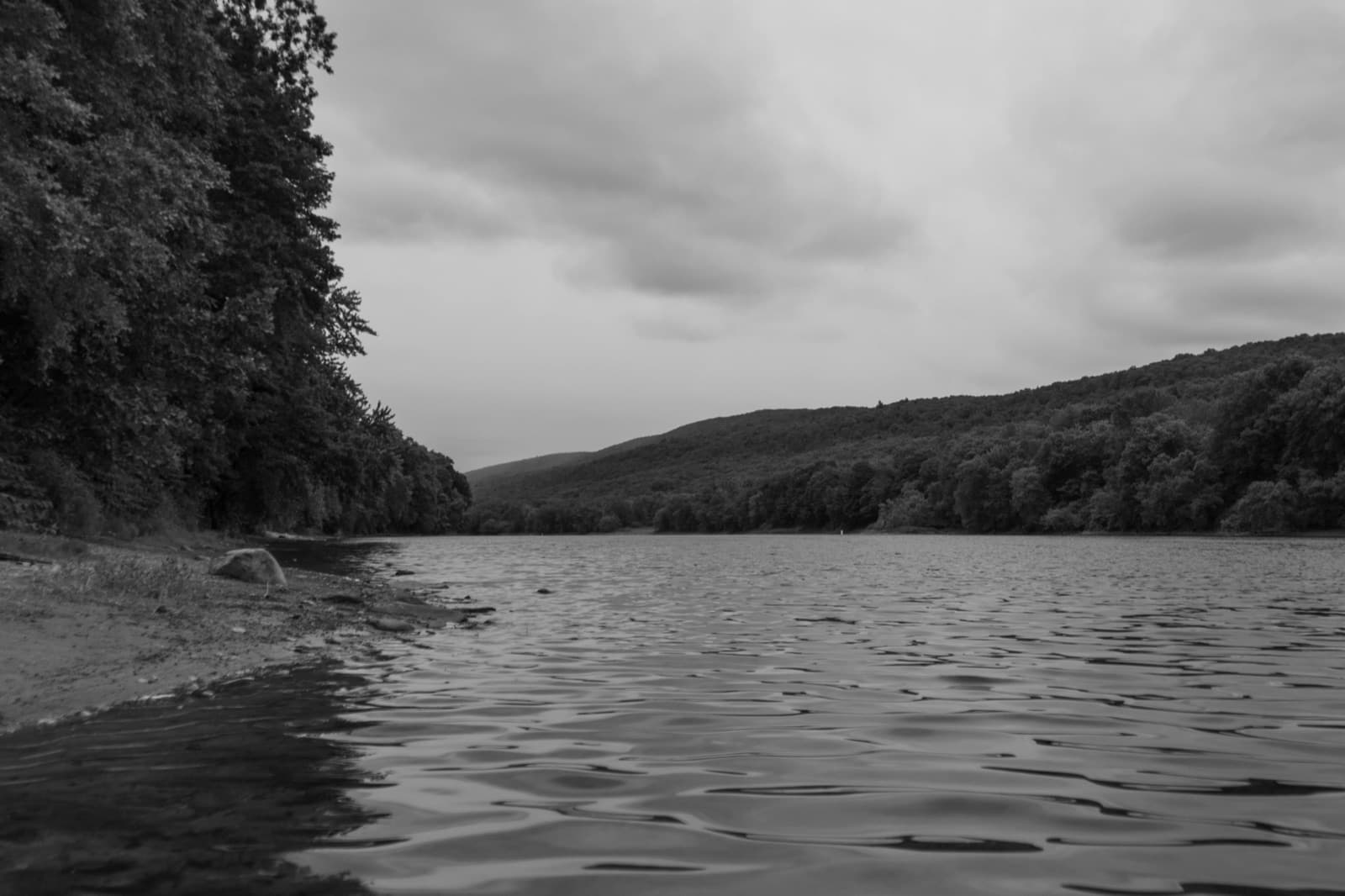 Black and white view of the Delaware River with dramatic sky